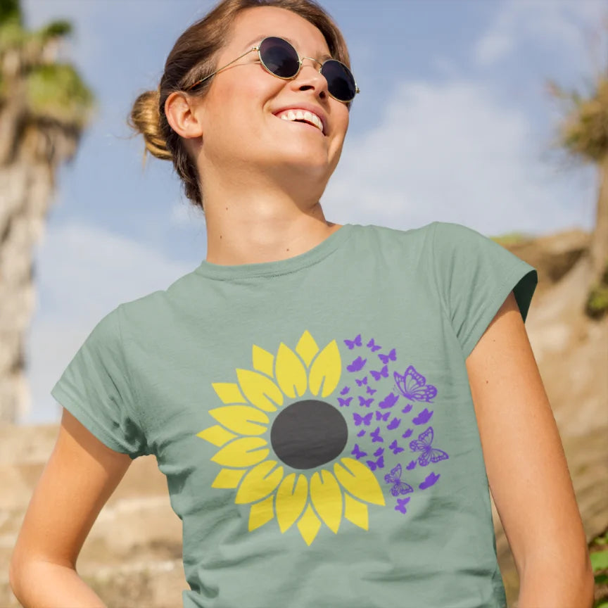 Woman wearing Sunflower T-Shirt Sage sacred yoga shirt outdoors in a sunlit field — The Vault collection by Ramro Yoga Wear