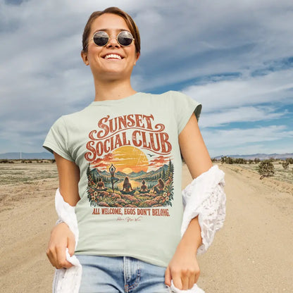 Person wearing the Sunset T-Shirt, Sunset Social Club design, standing on a desert road, in Citron color.