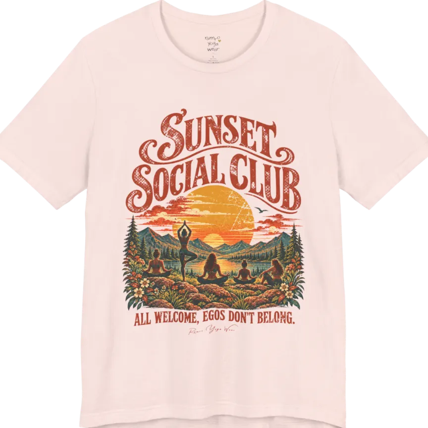 A short sleeved tee called the Sunset T-Shirt, flat lay and a Bella + Canvas 3001 shirt. Simply says, Sunset Social Club, All Welcome, Egos Don't Belong. Design highlights several people meditating together across a mountain landscape at sunset, with a large setting sun, pine trees, and florals, in a color vintage travel-poster illustration. Color is Soft Pink. 