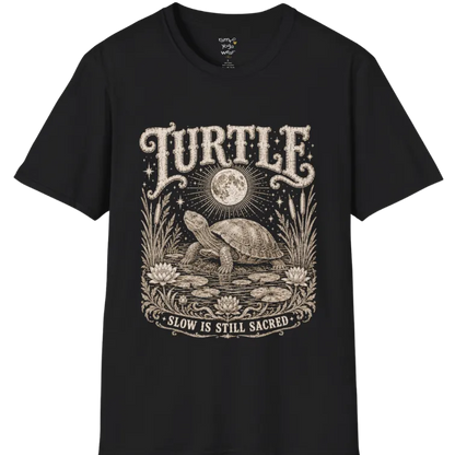 Turtle T-Shirt flat lay with a turtle resting beneath a full moon among lily pads and reeds by calm rippling water — vintage engraved graphic tee by Ramro Yoga Wear in Black.