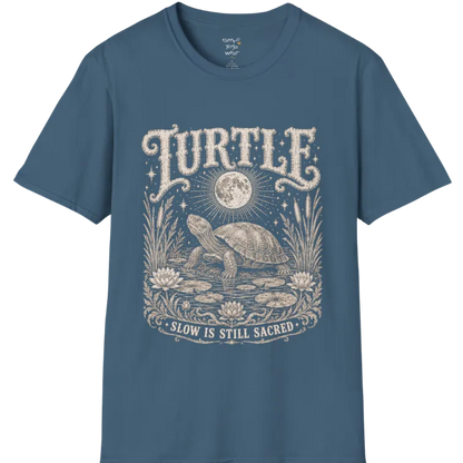Turtle T-Shirt flat lay with a turtle resting beneath a full moon among lily pads and reeds by calm rippling water — vintage engraved graphic tee by Ramro Yoga Wear in Indigo Blue.
