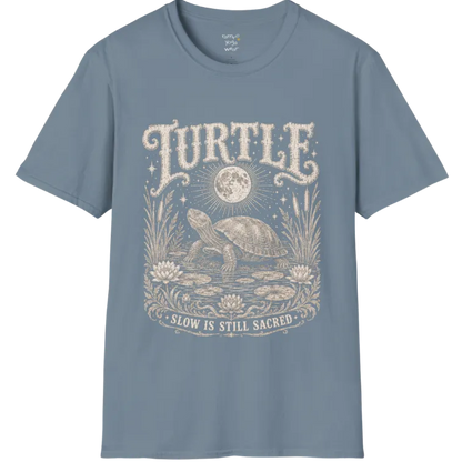 Turtle T-Shirt flat lay with a turtle resting beneath a full moon among lily pads and reeds by calm rippling water — vintage engraved graphic tee by Ramro Yoga Wear in Stone Blue.