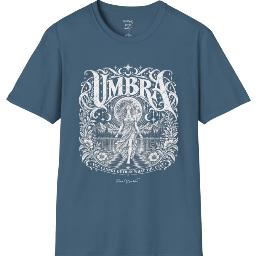 A short sleeved tee called the Umbra T-Shirt, flat lay and a Gildan 64000 shirt. Simply says, You Cannot Outrun What You Cast. Design highlights a moon goddess walking across still water toward distant mountains, framed in ornate vintage lettering with botanical detailing. Color is Indigo Blue.