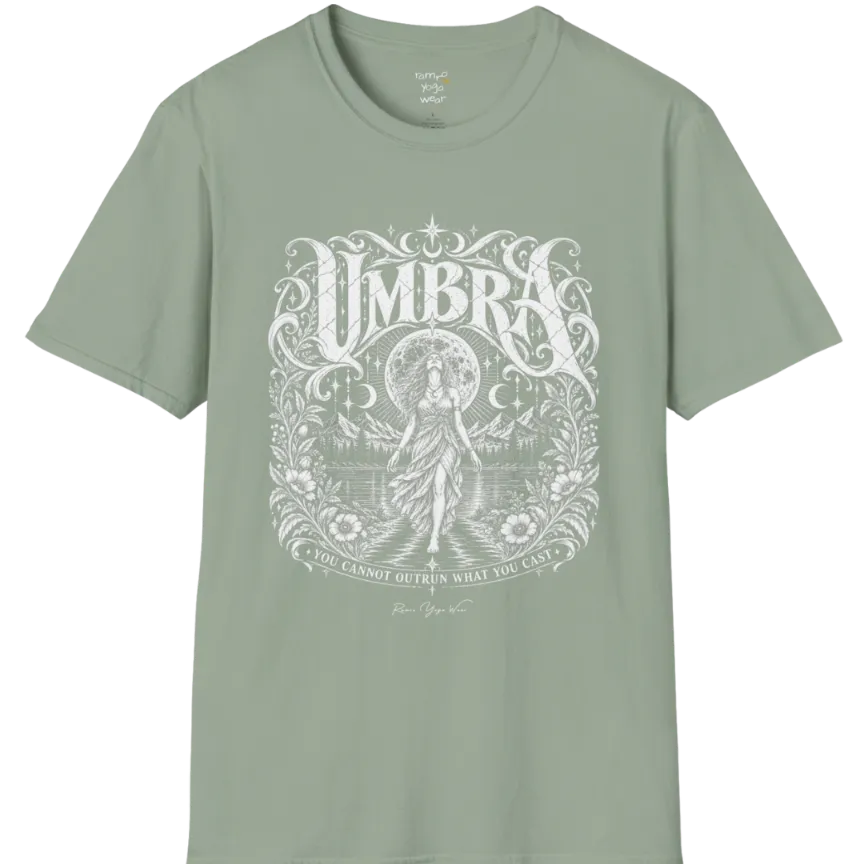 A short sleeved tee called the Umbra T-Shirt, flat lay and a Gildan 64000 shirt. Simply says, You Cannot Outrun What You Cast. Design highlights a moon goddess walking across still water toward distant mountains, framed in ornate vintage lettering with botanical detailing. Color is Sage.