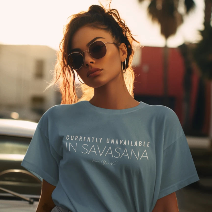 Woman wearing Unavailable Indigo Blue T-Shirt outdoors, sunglasses, golden hour light — The Vault collection by Ramro Yoga Wear