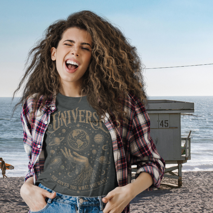 Woman wearing Universe dark heather grey sacred yoga shirt laughing at the beach — Sacred Thread collection by Ramro Yoga Wear