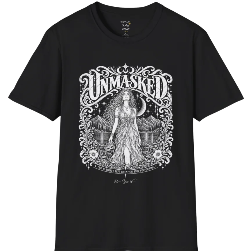 A short sleeved tee called the Unmasked T-Shirt, flat lay and a soft cotton shirt. Simply says, Unmasked. Design highlights an ornate floral crest in white linework with a long-haired figure in a flowing gown beneath a crescent moon, with Unmasked in ornate lettering across the top. Color is Black.