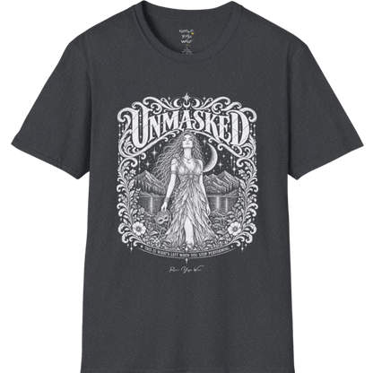A short sleeved tee called the Unmasked T-Shirt, flat lay and a soft cotton shirt. Simply says, Unmasked. Design highlights an ornate floral crest in white linework with a long-haired figure in a flowing gown beneath a crescent moon, with Unmasked in ornate lettering across the top. Color is Dark Heather Grey.