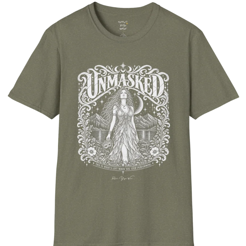 A short sleeved tee called the Unmasked T-Shirt, flat lay and a soft cotton shirt. Simply says, Unmasked. Design highlights an ornate floral crest in white linework with a long-haired figure in a flowing gown beneath a crescent moon, with Unmasked in ornate lettering across the top. Color is Heather Military Green.