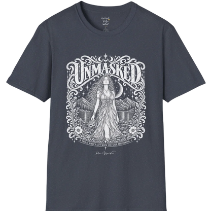 A short sleeved tee called the Unmasked T-Shirt, flat lay and a soft cotton shirt. Simply says, Unmasked. Design highlights an ornate floral crest in white linework with a long-haired figure in a flowing gown beneath a crescent moon, with Unmasked in ornate lettering across the top. Color is Heather Navy.