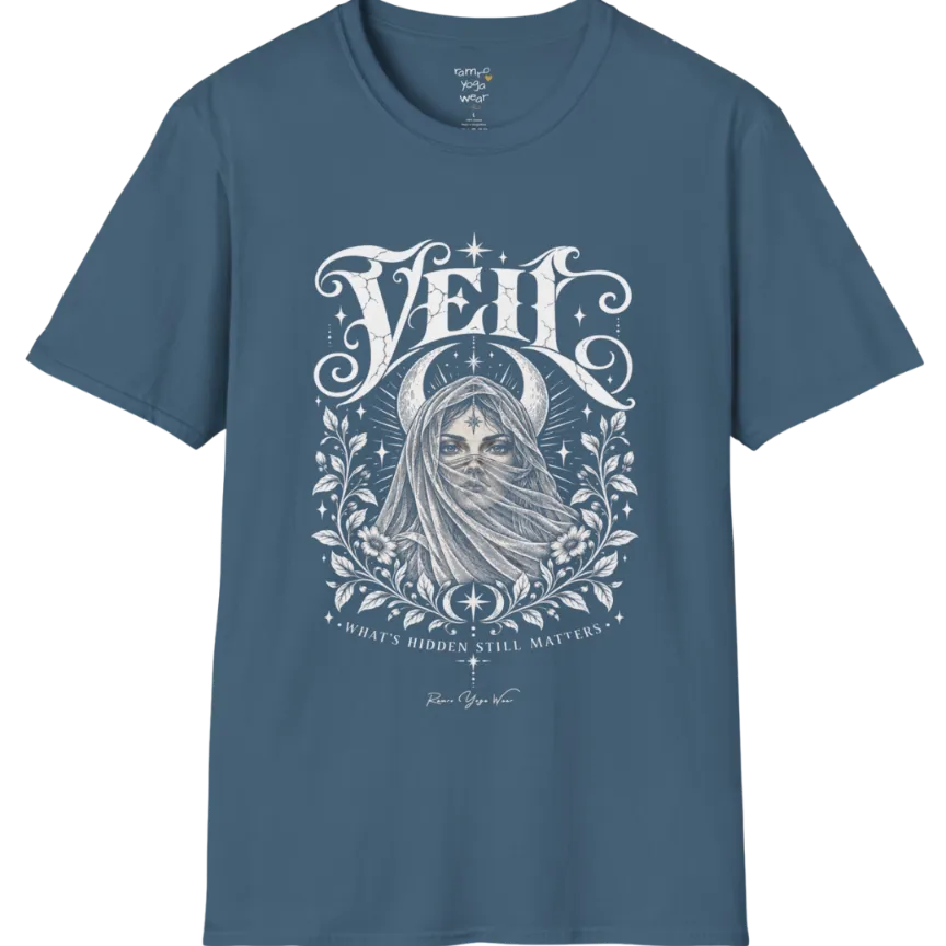 A short sleeved Tee, illustrated with a face partially obscured behind sheer draped fabric, a crescent moon behind, fine botanical framing at the base. Veil T-Shirt flat lay is a Gildan 64000 and the color is Indigo Blue.