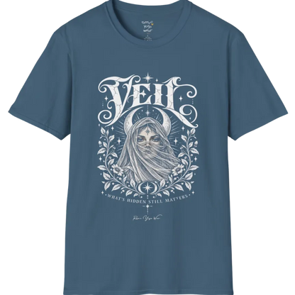 A short sleeved Tee, illustrated with a face partially obscured behind sheer draped fabric, a crescent moon behind, fine botanical framing at the base. Veil T-Shirt flat lay is a Gildan 64000 and the color is Indigo Blue.