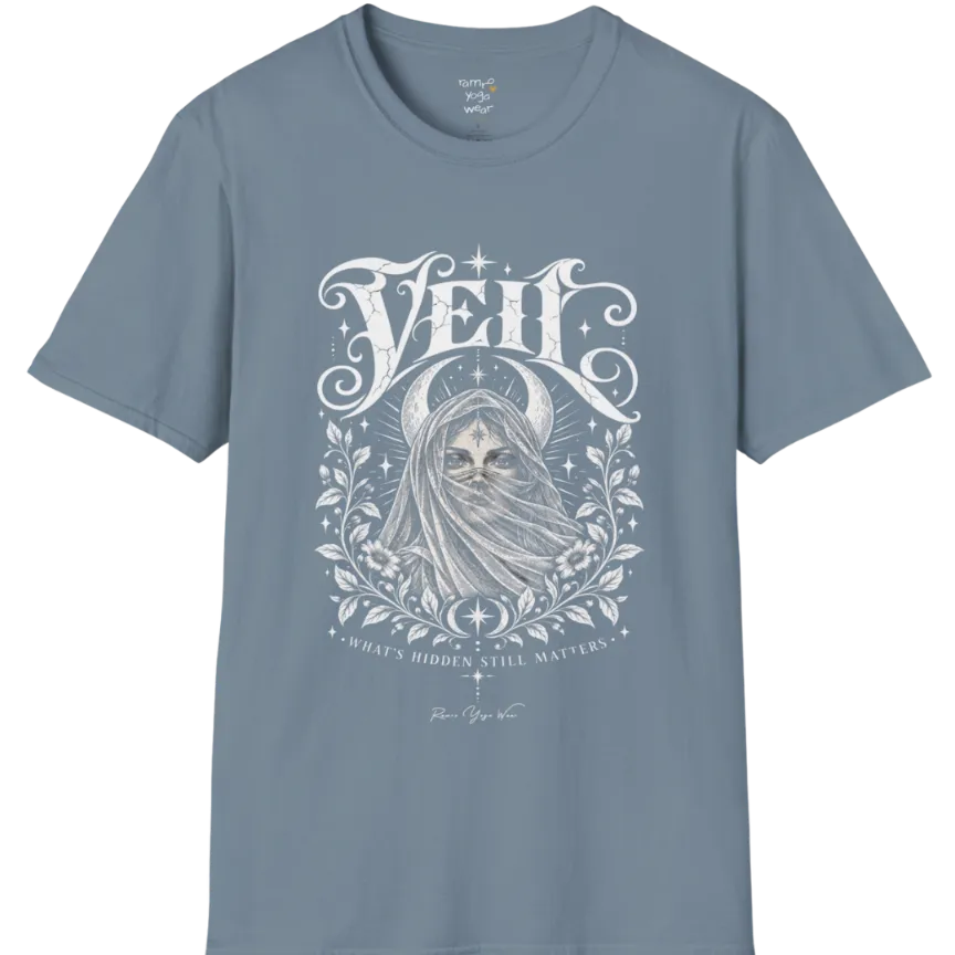 A short sleeved Tee, illustrated with a face partially obscured behind sheer draped fabric, a crescent moon behind, fine botanical framing at the base. Veil T-Shirt flat lay is a Gildan 64000 and the color is Stone Blue.