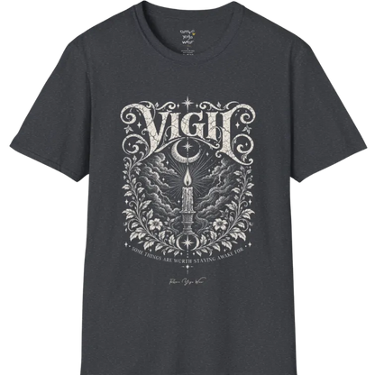 Short sleeved tee, illustration of a single candle burning steady against stormy clouds and wind lines, flame untouched, fine botanical framing at the base. Vigil T-Shirt flat lay is a Gildan 64000 and the color is Dark Heather Grey.