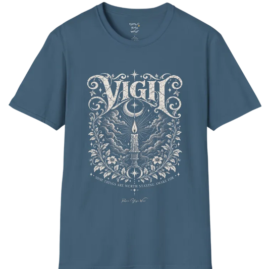 Short sleeved tee, illustration of a single candle burning steady against stormy clouds and wind lines, flame untouched, fine botanical framing at the base. Vigil T-Shirt flat lay is a Gildan 64000 and the color is Indigo Blue.