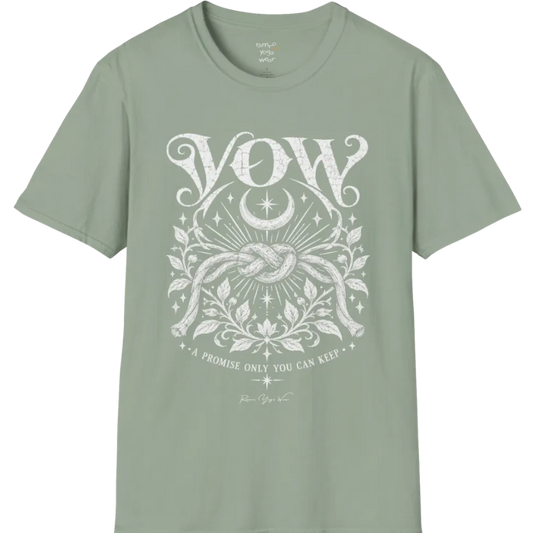 A short sleeved tee, illustrated with a single tied knot emblem and a crescent moon above, framed by fine botanical detailing. Vow T-Shirt flat lay is a Gildan 64000 and the color is Sage.
