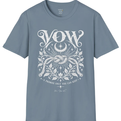 A short sleeved tee, illustrated with a single tied knot emblem and a crescent moon above, framed by fine botanical detailing. Vow T-Shirt flat lay is a Gildan 64000 and the color is Stone Blue.