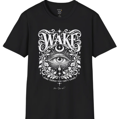 A short sleeved tee with an illustration of a single open eye amid darkness with a dewdrop caught mid-fall beneath it, faint stars scattered around, fine botanical framing at the base. Wake T-Shirt flat lay is a Gildan 64000 and the color is Black.