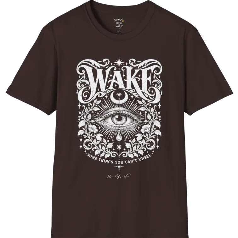 A short sleeved tee with an illustration of a single open eye amid darkness with a dewdrop caught mid-fall beneath it, faint stars scattered around, fine botanical framing at the base. Wake T-Shirt flat lay is a Gildan 64000 and the color is Dark Chocolate.