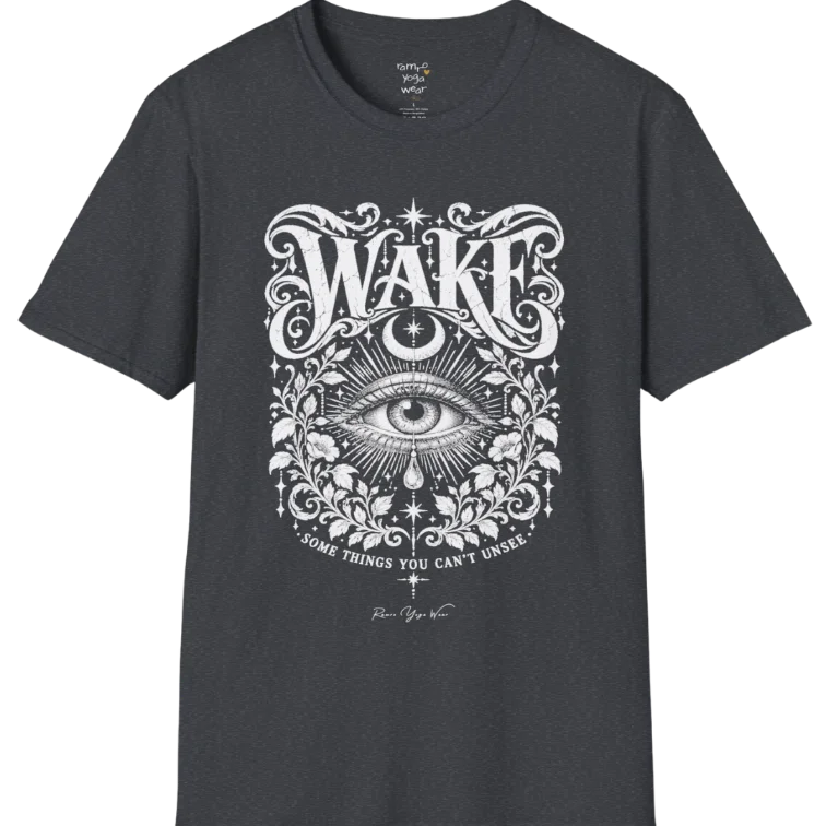 A short sleeved tee with an illustration of a single open eye amid darkness with a dewdrop caught mid-fall beneath it, faint stars scattered around, fine botanical framing at the base. Wake T-Shirt flat lay is a Gildan 64000 and the color is Dark Heather Grey.