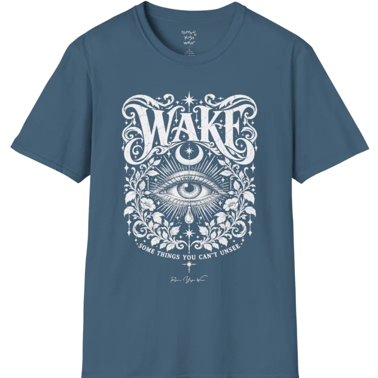 A short sleeved tee with an illustration of a single open eye amid darkness with a dewdrop caught mid-fall beneath it, faint stars scattered around, fine botanical framing at the base. Wake T-Shirt flat lay is a Gildan 64000 and the color is Indigo Blue.
