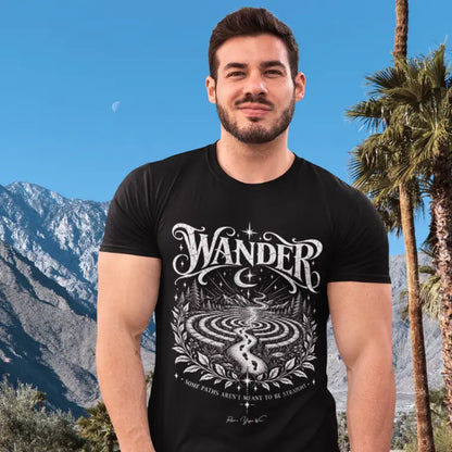 Man wearing Wander T-Shirt outdoors with mountains and palm trees behind him, shirt in Black.
