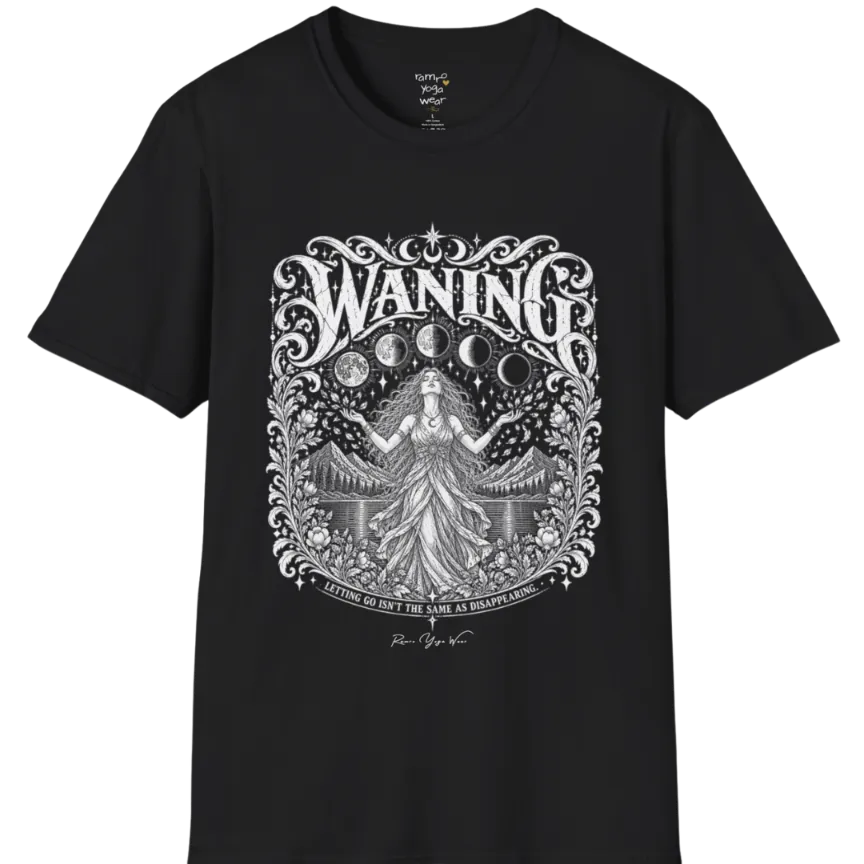A short sleeved tee called the Waning T-Shirt, flat lay and a Gildan 64000 shirt. Simply says, Waning, Letting Go Isn't The Same As Disappearing. Design highlights a vintage-engraved crest of a robed figure with long flowing hair and open hands releasing petals beneath five moon phases, with mountains, a still lake, stars and ornate floral framing. Color is Black.