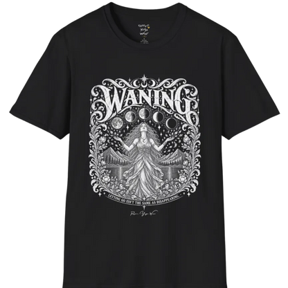A short sleeved tee called the Waning T-Shirt, flat lay and a Gildan 64000 shirt. Simply says, Waning, Letting Go Isn't The Same As Disappearing. Design highlights a vintage-engraved crest of a robed figure with long flowing hair and open hands releasing petals beneath five moon phases, with mountains, a still lake, stars and ornate floral framing. Color is Black.