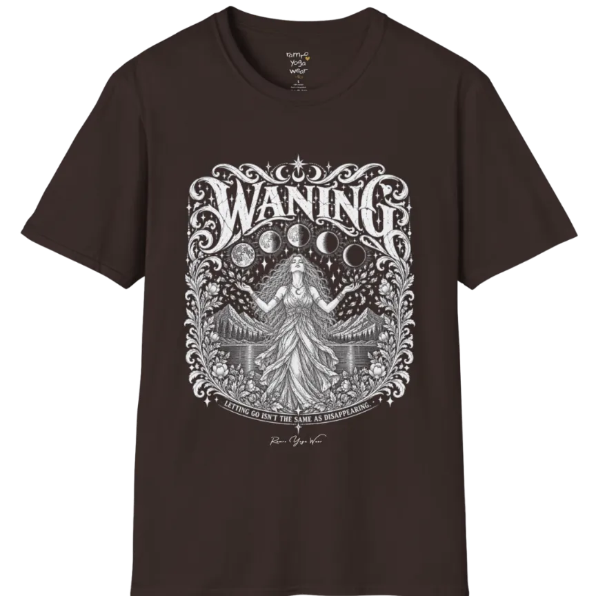 A short sleeved tee called the Waning T-Shirt, flat lay and a Gildan 64000 shirt. Simply says, Waning, Letting Go Isn't The Same As Disappearing. Design highlights a vintage-engraved crest of a robed figure with long flowing hair and open hands releasing petals beneath five moon phases, with mountains, a still lake, stars and ornate floral framing. Color is Dark Chocolate.