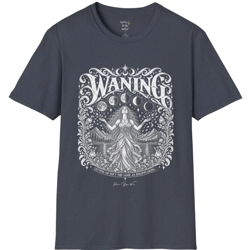 A short sleeved tee called the Waning T-Shirt, flat lay and a Gildan 64000 shirt. Simply says, Waning, Letting Go Isn't The Same As Disappearing. Design highlights a vintage-engraved crest of a robed figure with long flowing hair and open hands releasing petals beneath five moon phases, with mountains, a still lake, stars and ornate floral framing. Color is Heather Navy.