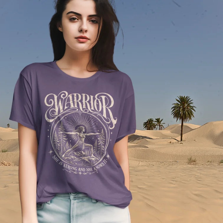 Woman wearing purple Warrior T-Shirt in desert-inspired outdoor setting with grounded spiritual fashion styling.