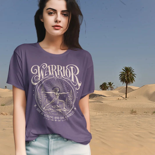 Woman wearing purple Warrior T-Shirt in desert-inspired outdoor setting with grounded spiritual fashion styling.
