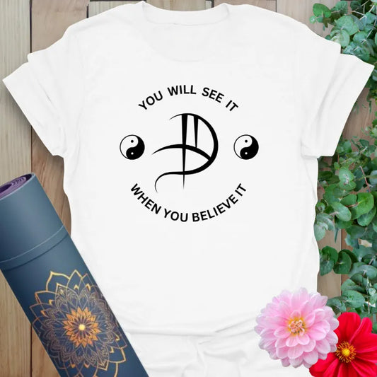 White Believe It T-Shirt with spiritual affirmation and balance symbol graphic