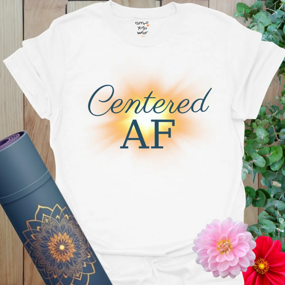 White Centered AF T-Shirt with navy blue lettering and a warm sunburst glow. Lightweight yoga tee designed for calm confidence and everyday balance.
