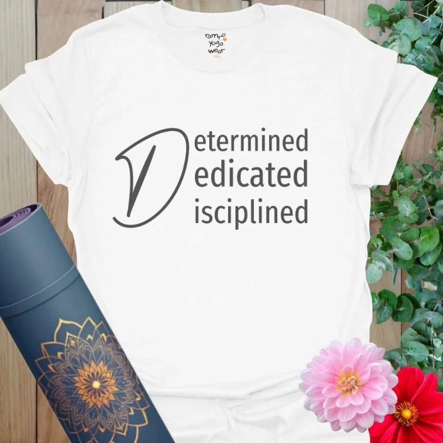 White Determined T-Shirt featuring “Determined, Dedicated, Disciplined” mantra in elegant black text. A clean and bold look for purposeful yogis.