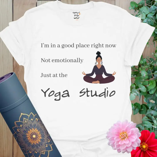 White yoga t-shirt with seated meditating woman illustration and humorous yoga studio quote.