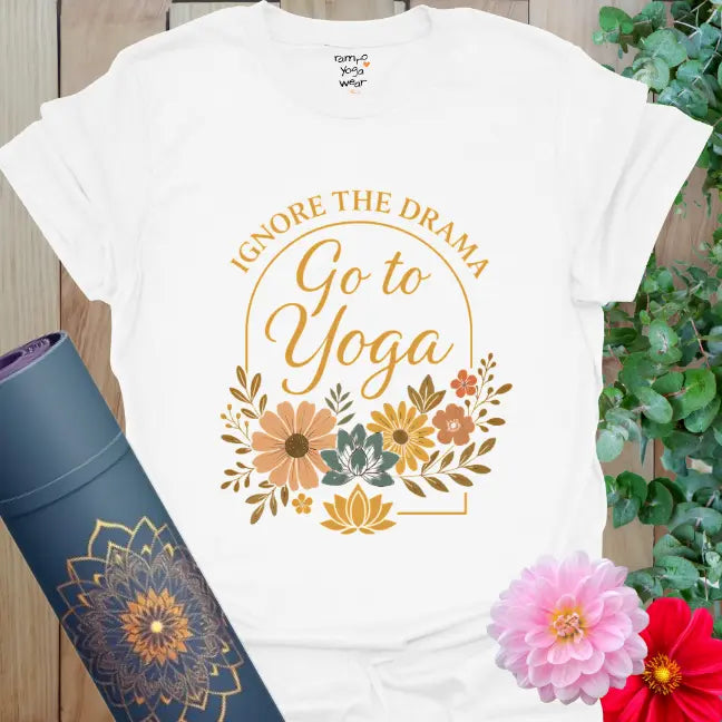 Soft floral arch artwork with “Ignore the Drama – Go to Yoga” text on a white tee, calm and minimalist.