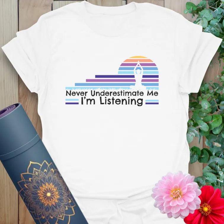Clean white unisex yoga t-shirt featuring colorful retro sunset and mindful listening empowerment mantra.