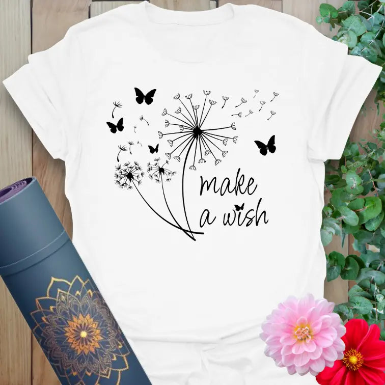 Clean white unisex yoga t-shirt featuring delicate dandelion and butterfly design with inspiring "Make a Wish" affirmation.