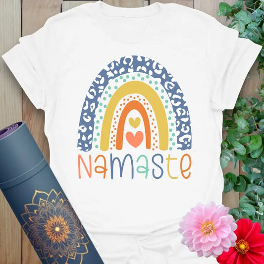 Clean white unisex yoga t-shirt featuring vibrant rainbow and playful Namaste design for soulful gratitude and happy mindful living.
