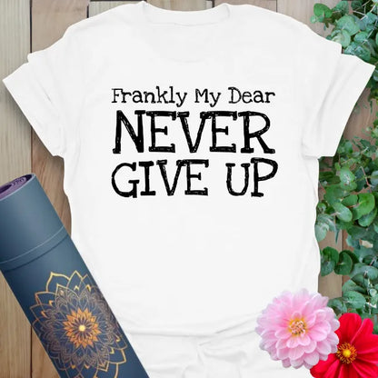 Clean white unisex yoga t-shirt featuring inspiring "Never Give Up" quote for conscious, empowered daily movement.