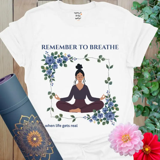 White Remember to Breathe T-Shirt with serene yogi illustration framed in blue florals, calm yoga design for mindful movement.