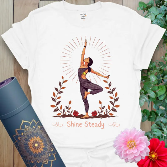 Clean white unisex yoga t-shirt featuring powerful tree pose yogi with sunburst and “Shine Steady” text for conscious, heart-centered living.