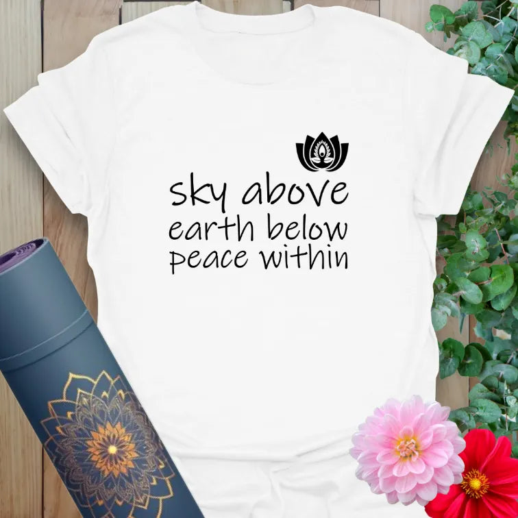Clean white unisex yoga t-shirt featuring peaceful mantra and lotus flower art inspiring grounded presence and soulful movement.