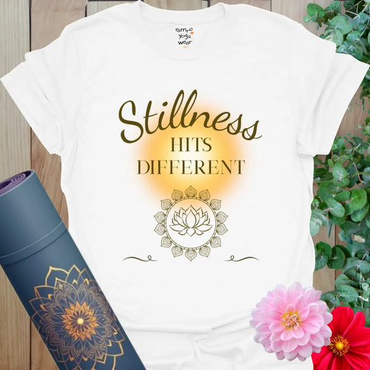 White Stillness Hits T-Shirt featuring elegant golden lettering and peaceful lotus artwork. A soulful shirt for breathwork, yoga, and rest days.