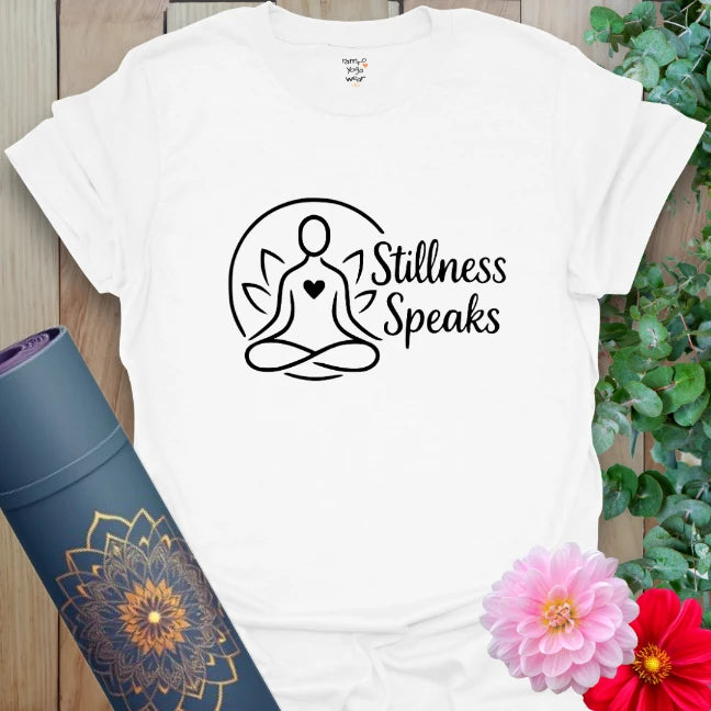 Clean white tee featuring peaceful meditating figure and heart-centered “Stillness Speaks” typography for mindful moments.