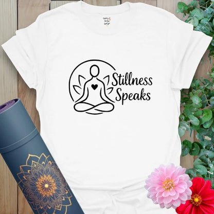 Clean white tee featuring peaceful meditating figure and heart-centered “Stillness Speaks” typography for mindful moments.