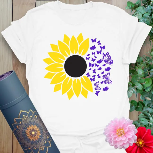Clean white unisex t-shirt featuring bright sunflower bloom and butterfly movement for growth, grace, and sunshine energy.