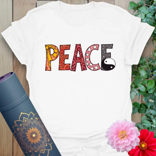 Clean white unisex tee with colorful “PEACE” word art and balance symbol for peaceful, playful style.