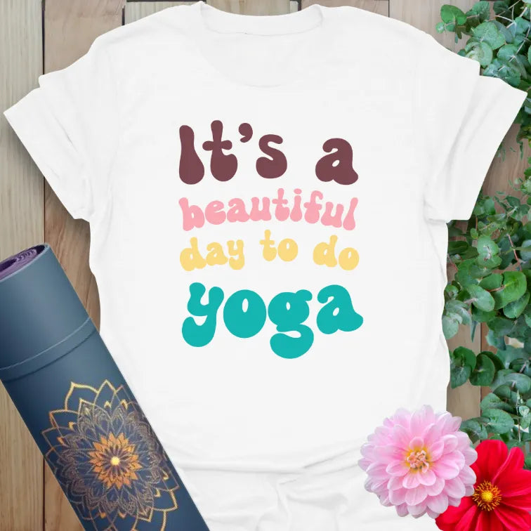 Clean white unisex tee with colorful yoga message for lighthearted spiritual expression and daily inspiration.